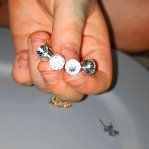 2 different sized silver earrings